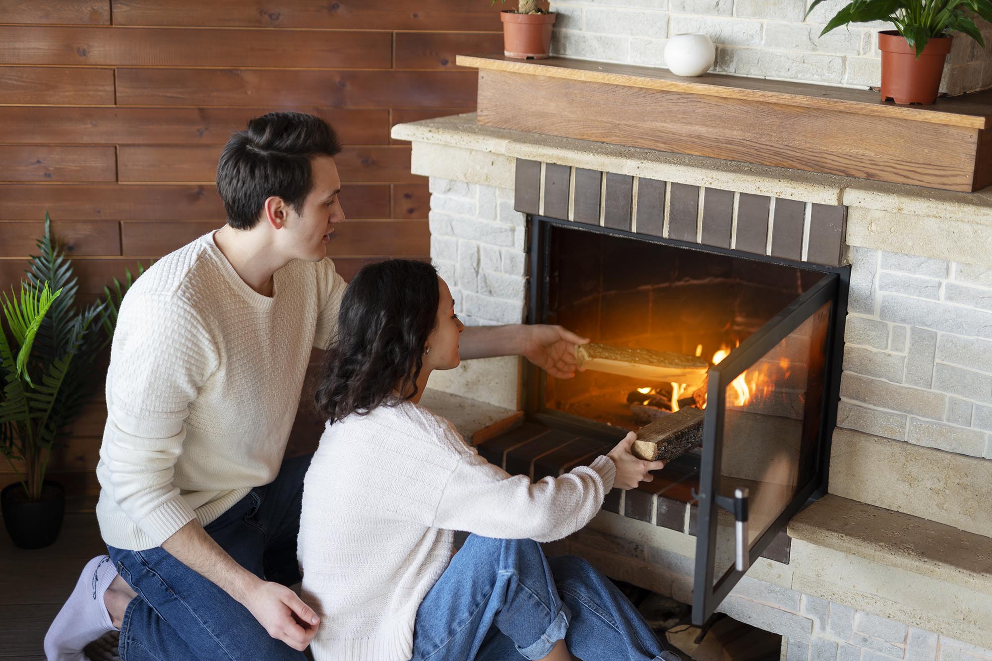 high-angle-people-sitting-by-fireplace